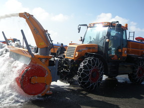Bagger mit Schneeketten und Schneefräse